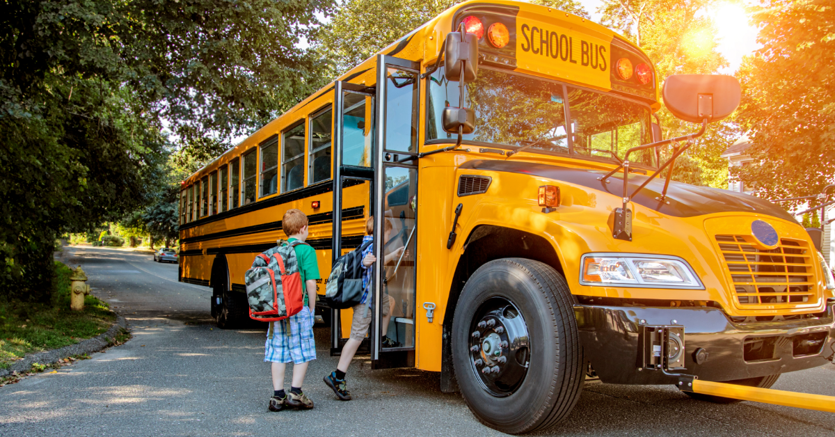 students getting on a bus